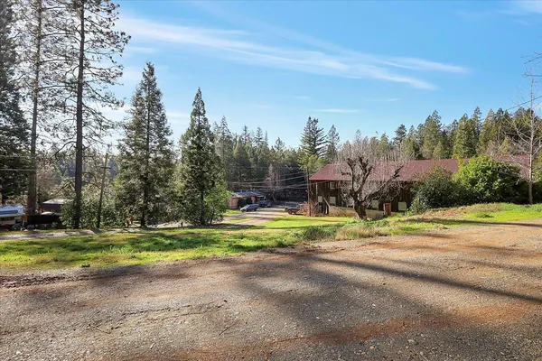 a view of a house with a yard and garage