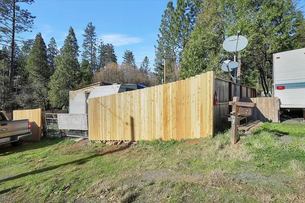 a backyard of a house with table and chairs