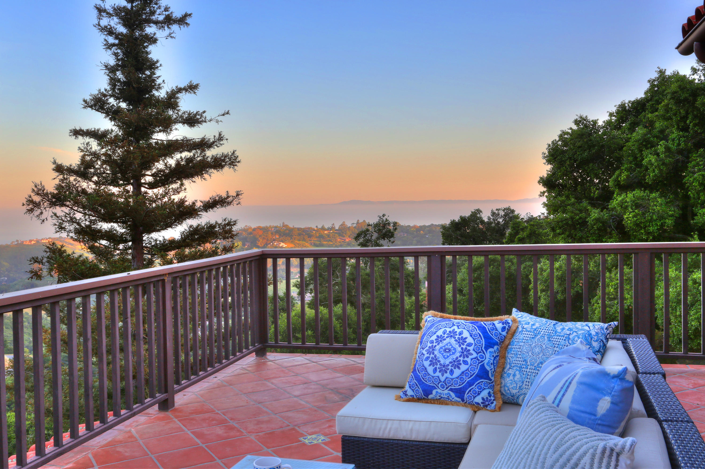 2220 Gibraltar Road Santa Barbara, CA 93103 - Photo 1 of 21 a balcony with wooden floor and outdoor seating
