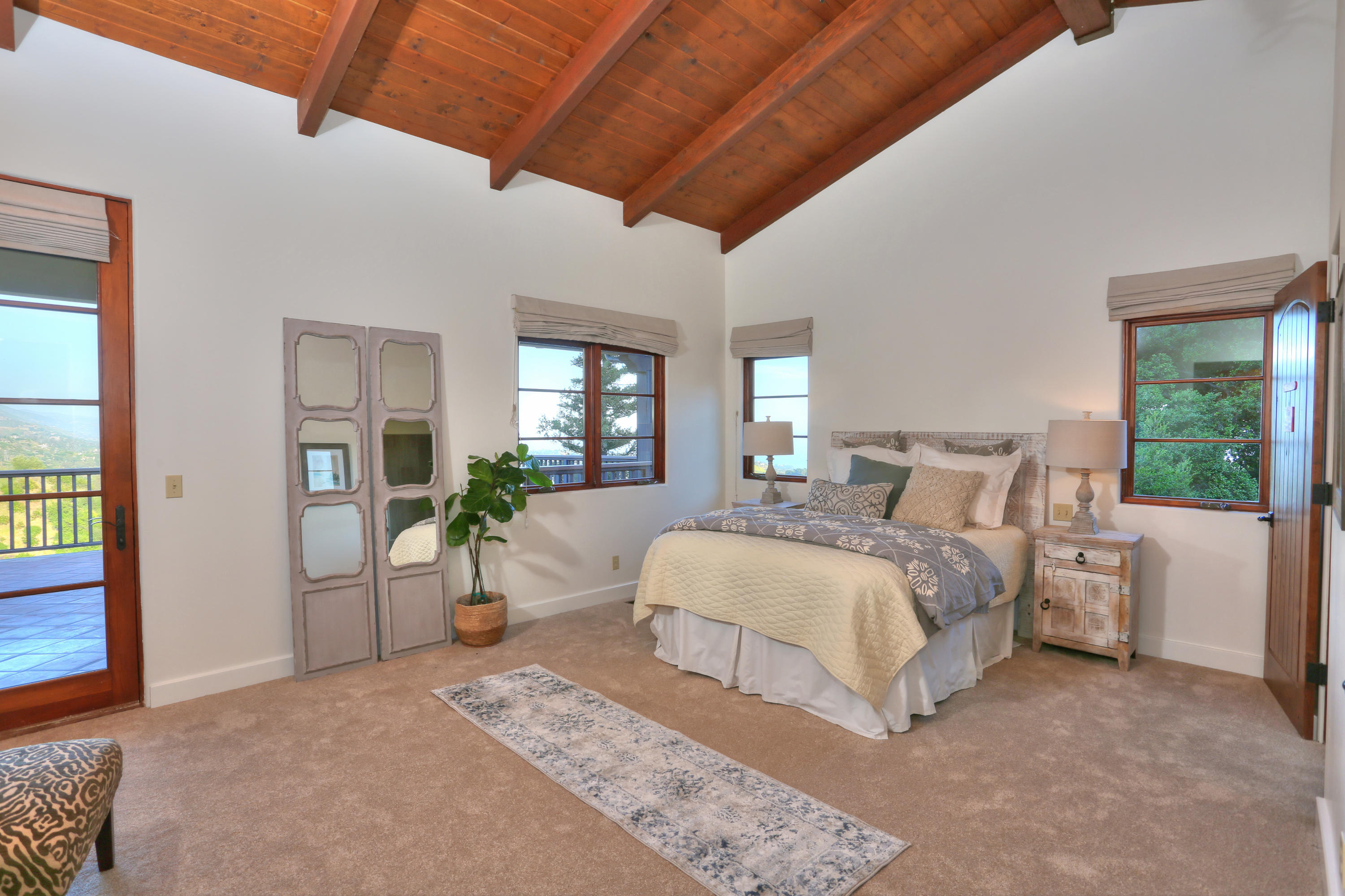 2220 Gibraltar Road Santa Barbara, CA 93103 - Photo 9 of 21 a bedroom with a large bed and a chandelier