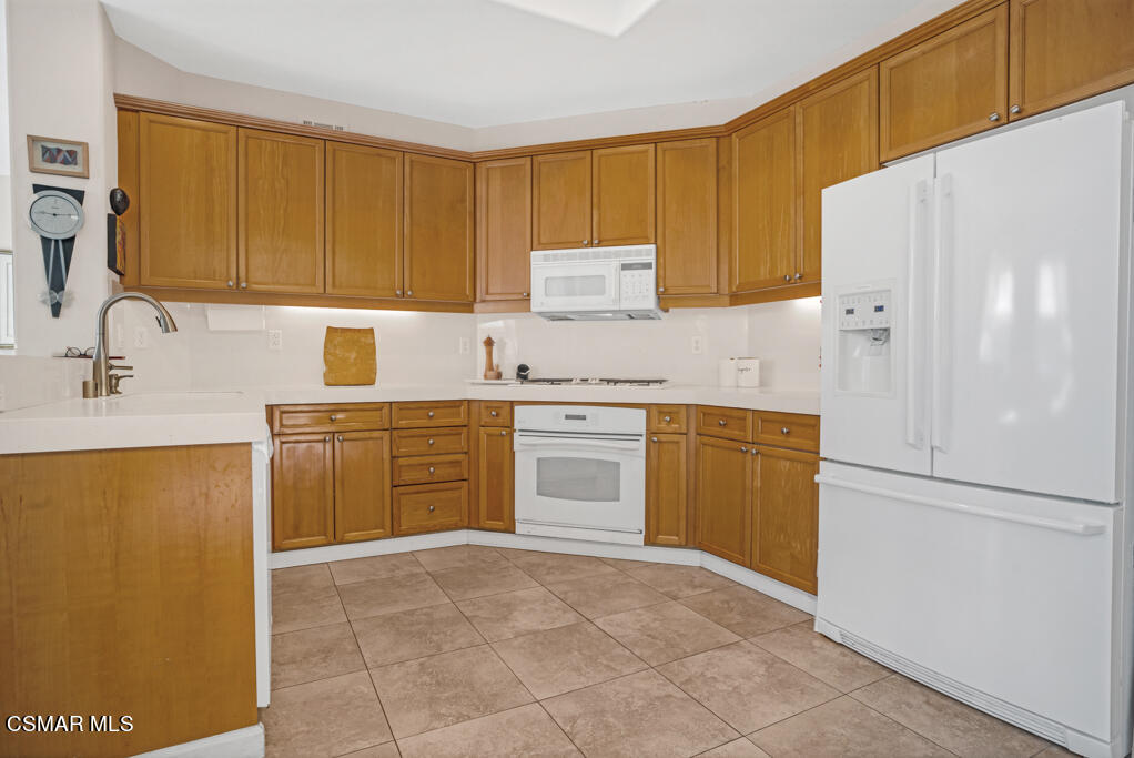 1138 Corte Riviera Camarillo, CA 93010 - Photo 12 of 40 a kitchen with a stove sink and refrigerator