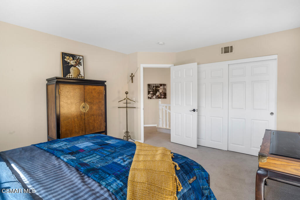 1138 Corte Riviera Camarillo, CA 93010 - Photo 31 of 40 a bedroom with a bed and wooden floor