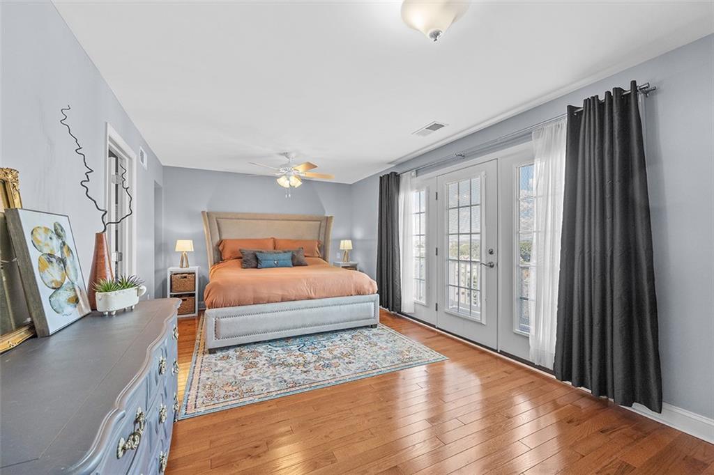 11 Natchez Street Pittsburgh, PA 15211 - Photo 13 of 25 a bedroom with a large bed and a flat tv screen on dresser