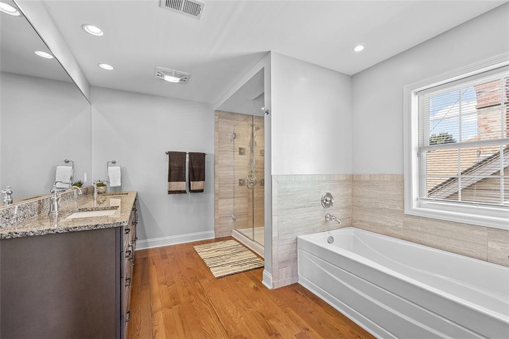 11 Natchez Street Pittsburgh, PA 15211 - Photo 15 of 25 a bathroom with a granite countertop tub sink a mirror and a bathtub