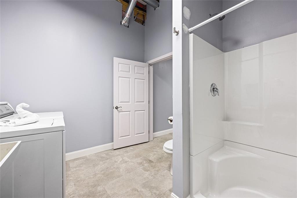 11 Natchez Street Pittsburgh, PA 15211 - Photo 20 of 25 a bathroom with a granite countertop sink a mirror and shower
