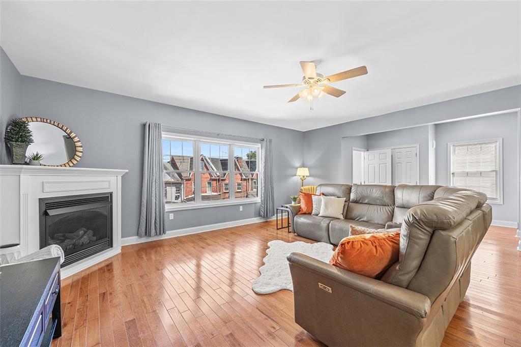 11 Natchez Street Pittsburgh, PA 15211 - Photo 6 of 25 a living room with furniture and a fireplace