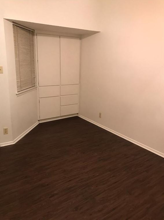 2604 Salado Street, Unit 104 Austin, TX 78705 - Photo 2 of 8 an empty room with wooden floor