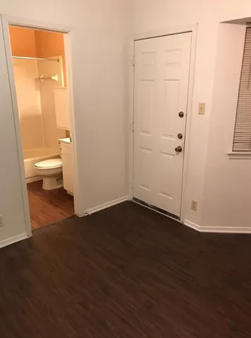 a view of a bathroom with wooden floor and a sink