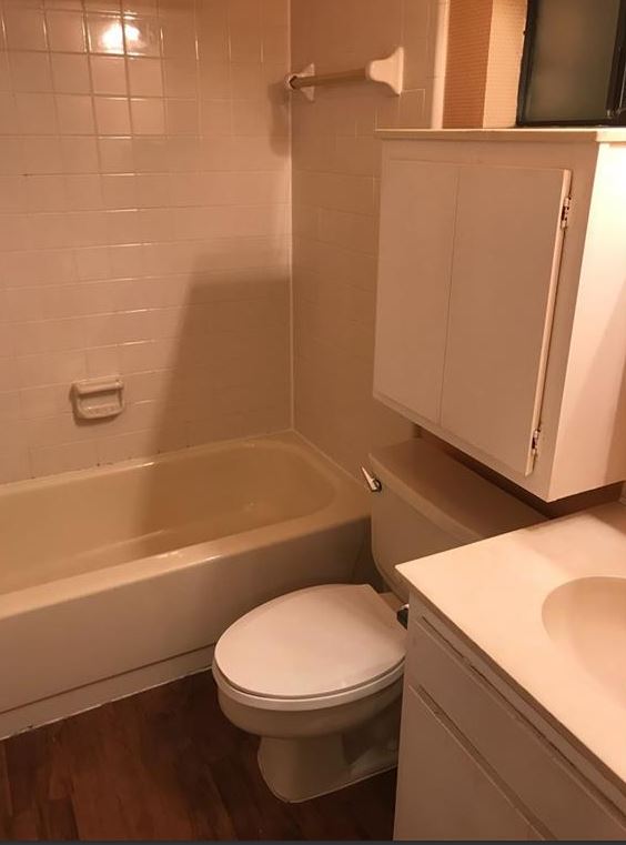 2604 Salado Street, Unit 104 Austin, TX 78705 - Photo 6 of 8 a bathroom with a toilet a sink and bathtub