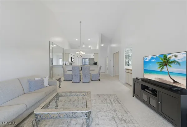 a spacious bedroom with a bed and a flat screen tv