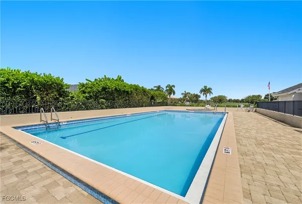 a patio with glass top table and chairs
