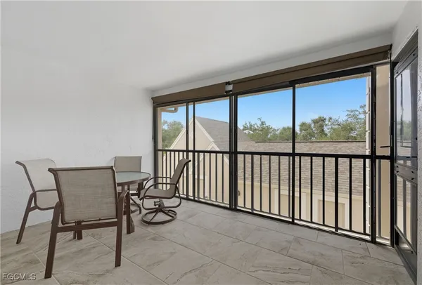 a view of a chairs and table in the balcony