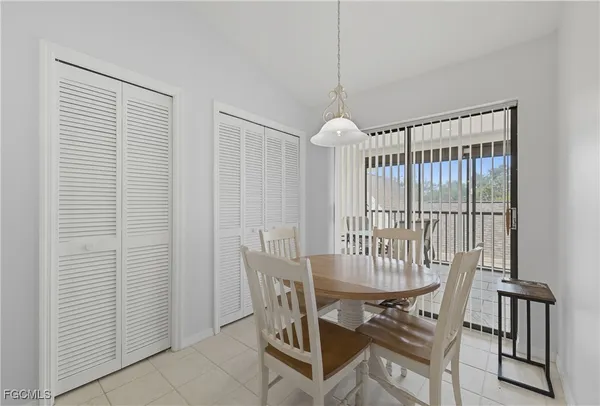 a view of a dining room with furniture and window