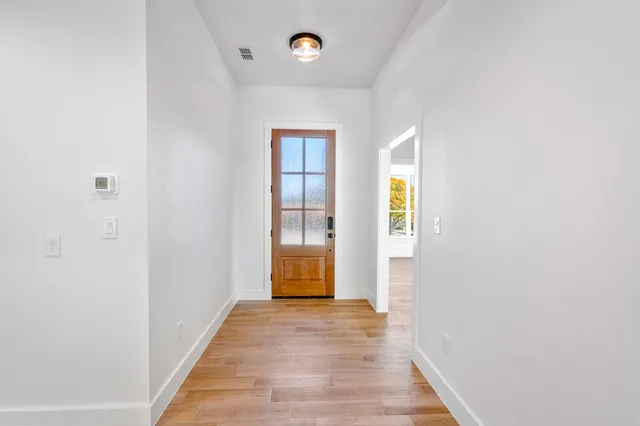 a view of an entryway with wooden floor