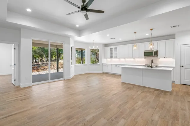 a view of kitchen with refrigerator and wooden floor