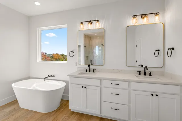 a bathroom with double vanity sinks and a mirror