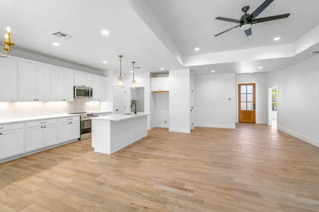 a view of a kitchen with a sink hardwood floor and a kitchen