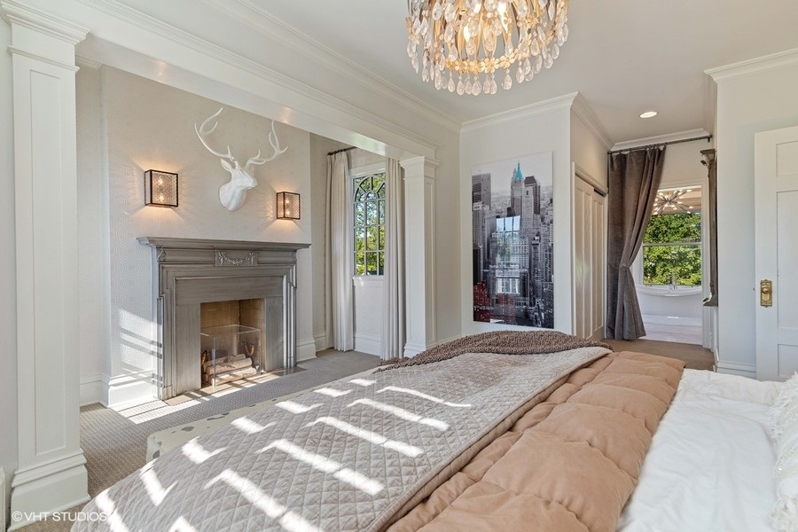 236 Melrose Avenue Elmhurst, IL 60126 - Photo 22 of 50 a bedroom with a large bed and a fireplace