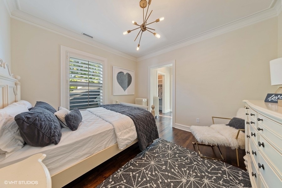 236 Melrose Avenue Elmhurst, IL 60126 - Photo 28 of 50 a bedroom with a bed and a chandelier