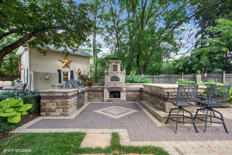 236 Melrose Avenue Elmhurst, IL 60126 - Photo 41 of 50 a view of a patio with table and chairs potted plants and large tree