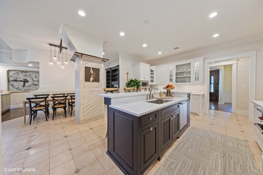 236 Melrose Avenue Elmhurst, IL 60126 - Photo 10 of 50 a kitchen with kitchen island granite countertop a sink counter top space and stainless steel appliances