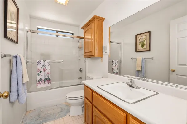 a bathroom with a sink toilet tub and shower