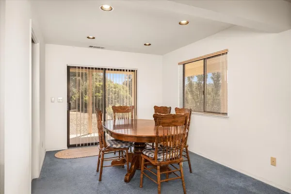 a dining room with furniture and window