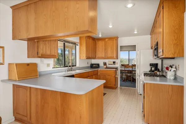 a kitchen with stainless steel appliances a refrigerator sink and cabinets