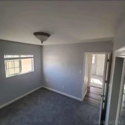 an empty room with windows and entrance