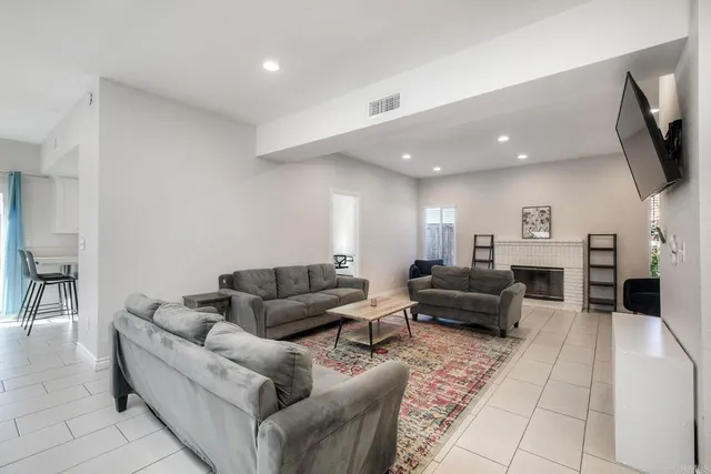 a view of livingroom with furniture fireplace and window