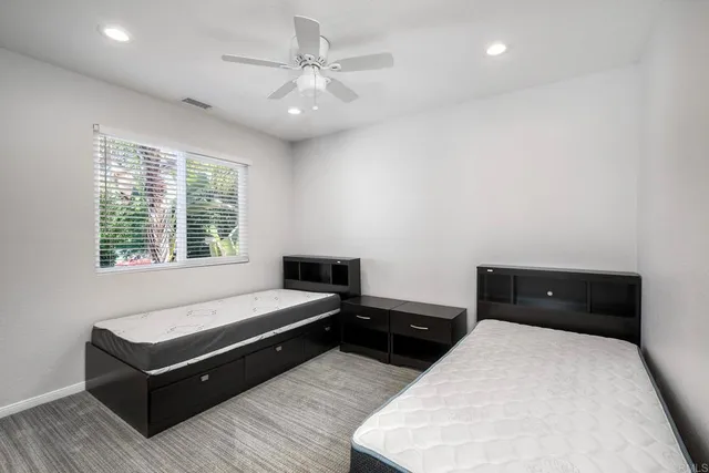 a bathroom with a granite countertop sink mirror and shower