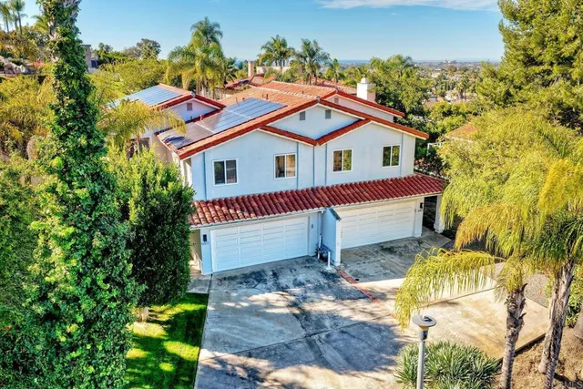 an aerial view of multiple houses with yard