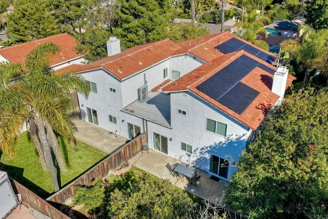 a kitchen with a refrigerator and a dining table