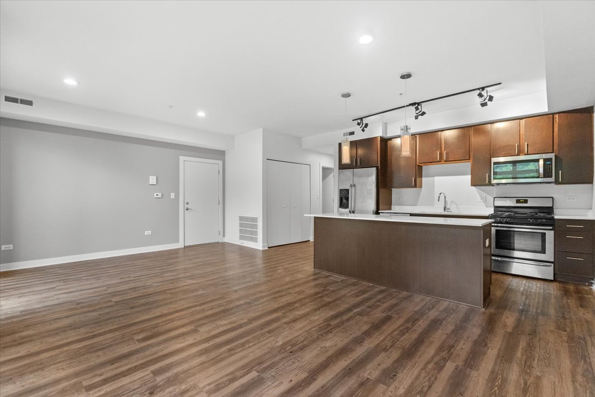 500 North Northwest Highway, Unit 111 Park Ridge, IL 60068 - Photo 3 of 12 a kitchen with stainless steel appliances granite countertop a refrigerator and a stove top oven