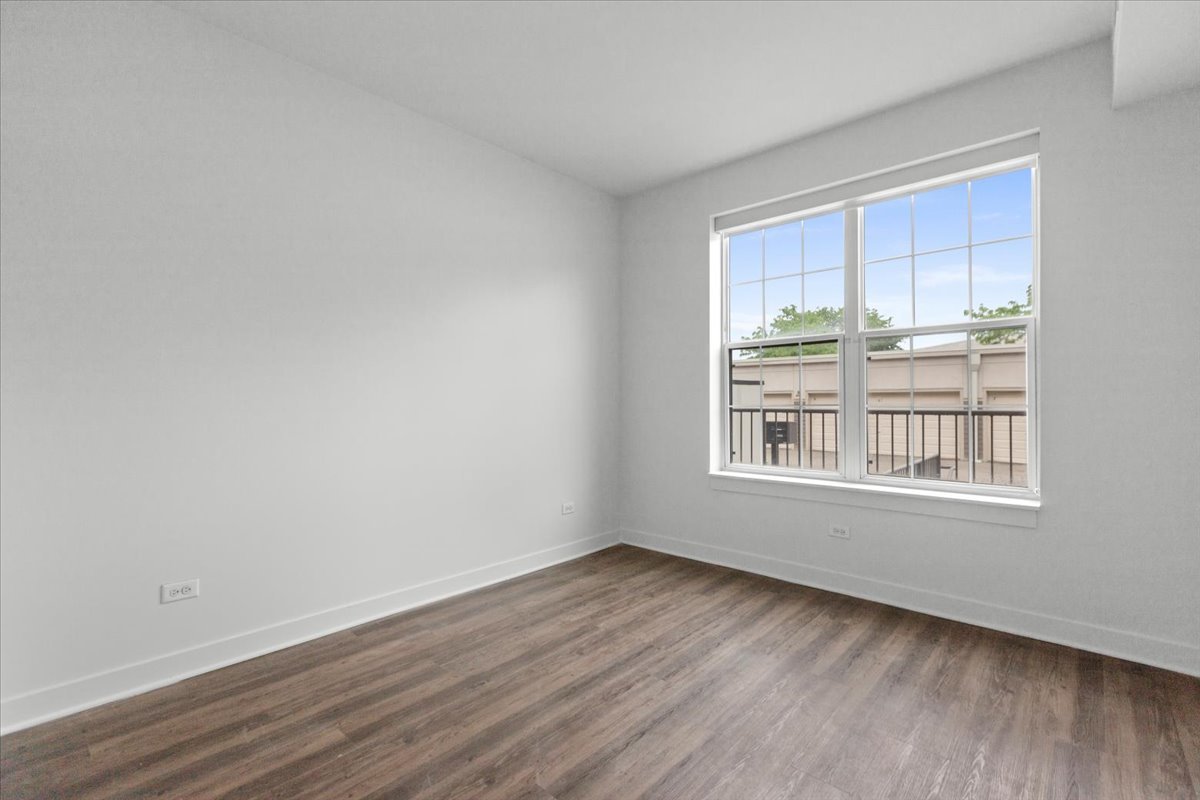500 North Northwest Highway, Unit 111 Park Ridge, IL 60068 - Photo 7 of 12 a view of an empty room with wooden floor and a window