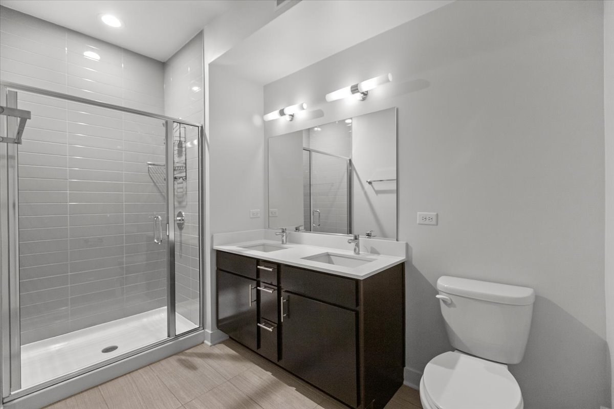 500 North Northwest Highway, Unit 111 Park Ridge, IL 60068 - Photo 8 of 12 a bathroom with a toilet sink and shower