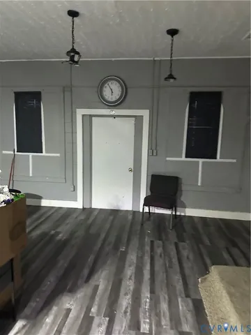 a view of empty room with wooden floor and window