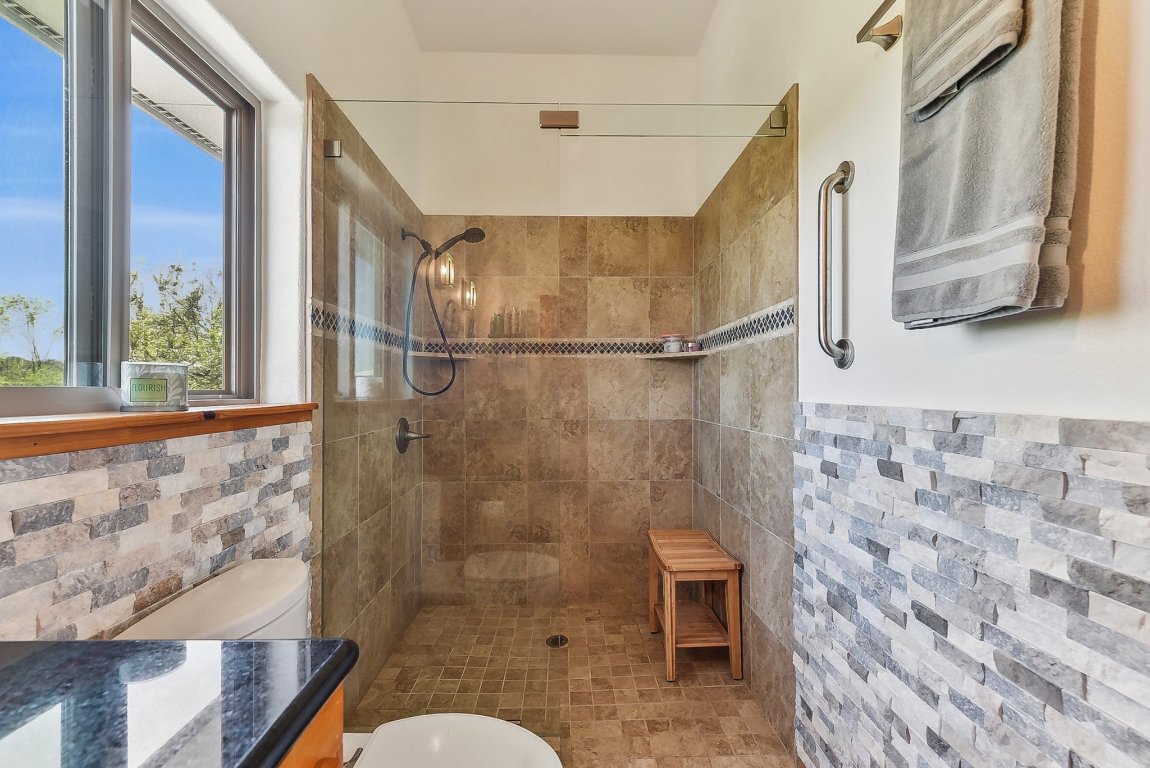 1813 Graveyard Point Road Austin, TX 78734 - Photo 23 of 40 a bathroom with a toilet and a shower