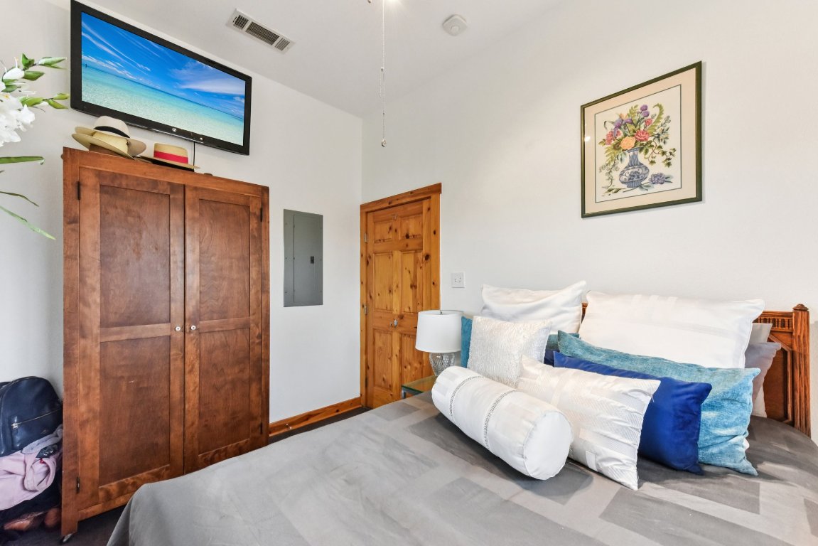 1813 Graveyard Point Road Austin, TX 78734 - Photo 24 of 40 a bedroom with a bed and a television