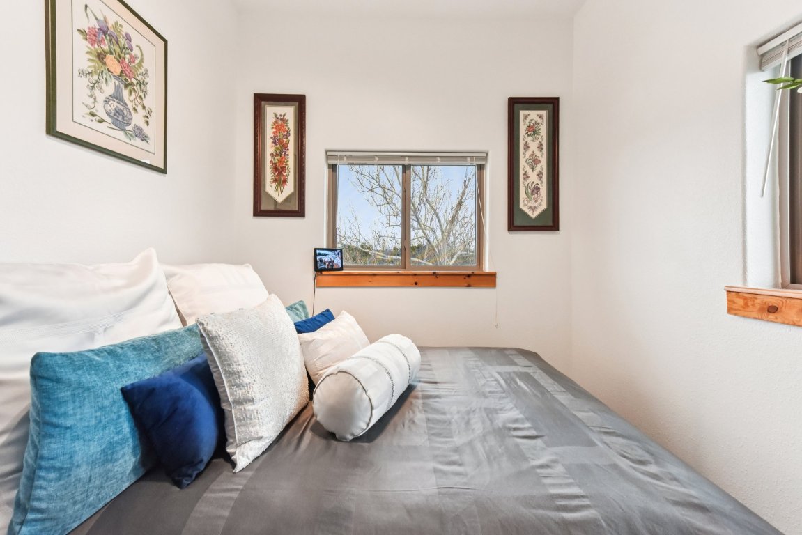 1813 Graveyard Point Road Austin, TX 78734 - Photo 25 of 40 a bedroom with a bed and painting on the wall