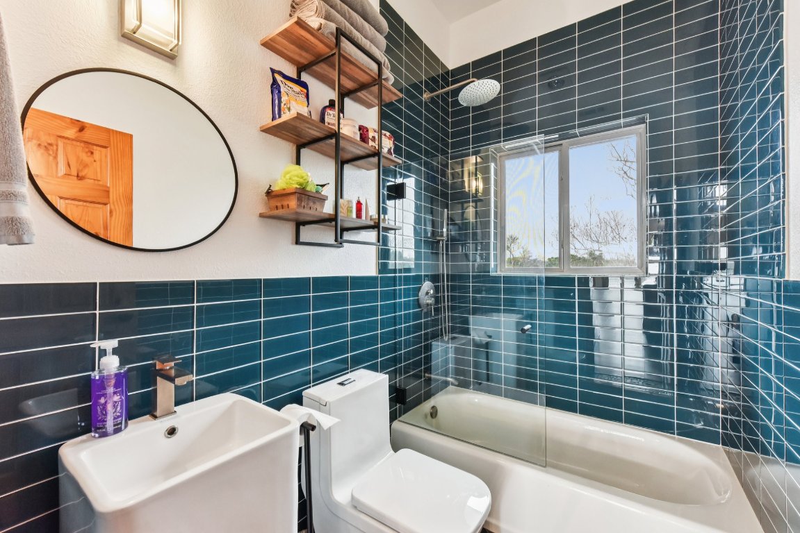 1813 Graveyard Point Road Austin, TX 78734 - Photo 26 of 40 a bathroom with a toilet a sink and bathtub