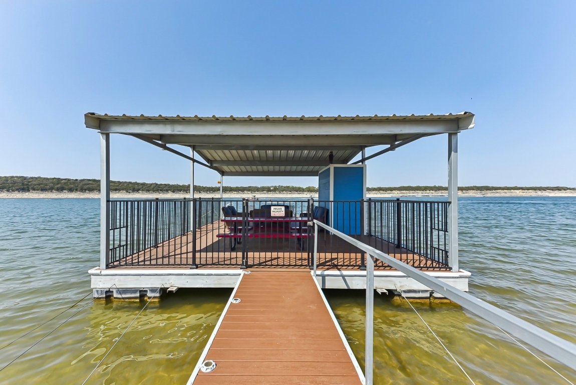 1813 Graveyard Point Road Austin, TX 78734 - Photo 34 of 40 a view of a balcony with two chairs and a table