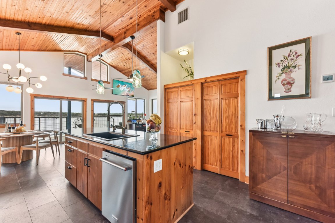 1813 Graveyard Point Road Austin, TX 78734 - Photo 7 of 40 a kitchen with stainless steel appliances granite countertop a sink and cabinets