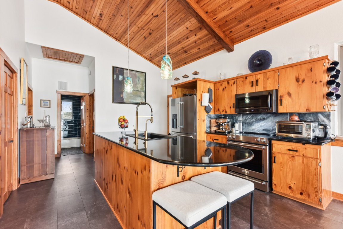 1813 Graveyard Point Road Austin, TX 78734 - Photo 9 of 40 a kitchen with stainless steel appliances granite countertop a sink a stove counter space and stainless steel appliances