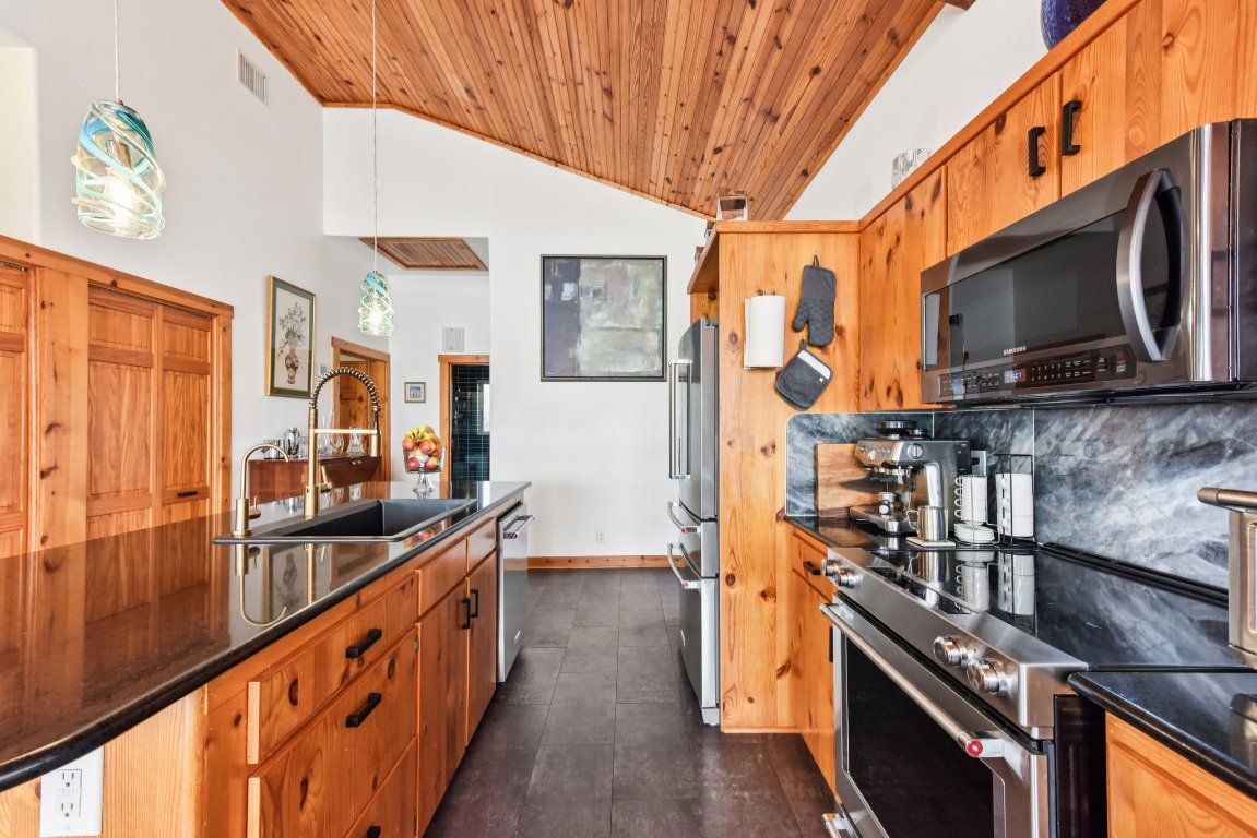 1813 Graveyard Point Road Austin, TX 78734 - Photo 10 of 40 a kitchen with stainless steel appliances granite countertop a stove and a sink