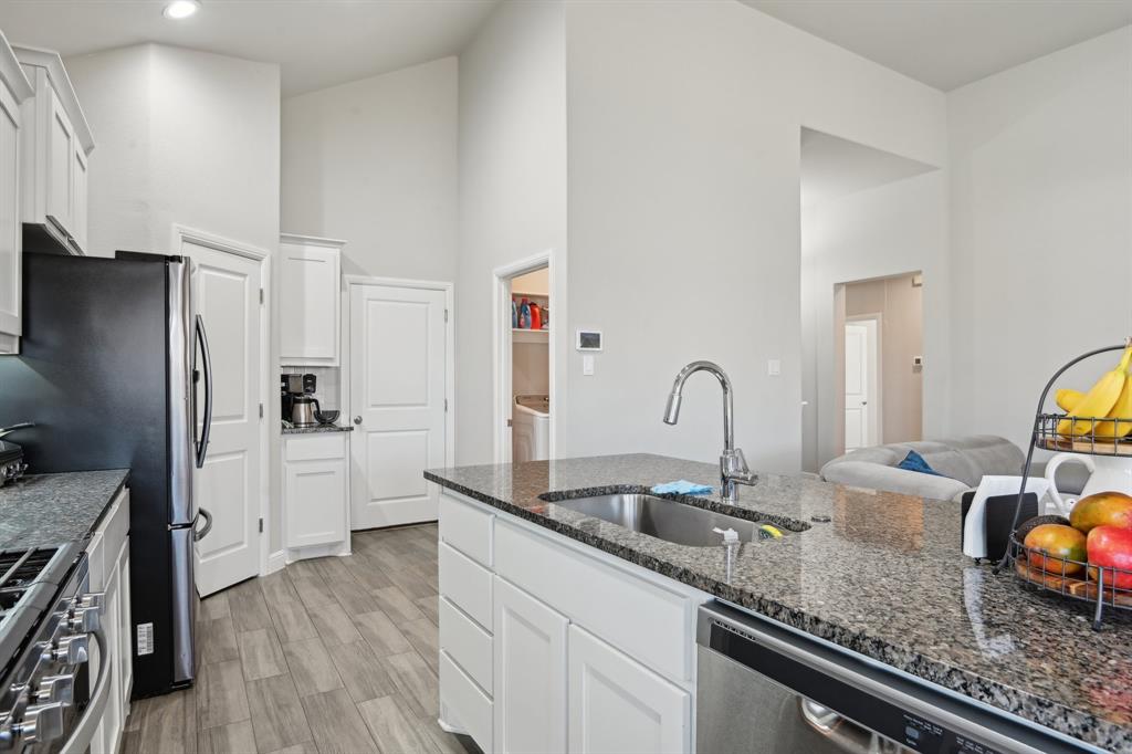 1504 Rachel Street Northlake, TX 76247 - Photo 12 of 40 a kitchen with granite countertop a sink stainless steel appliances and cabinets