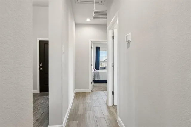 a view of a hallway with wooden floor