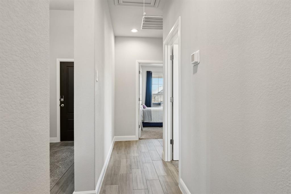 1504 Rachel Street Northlake, TX 76247 - Photo 18 of 40 a view of a hallway with wooden floor