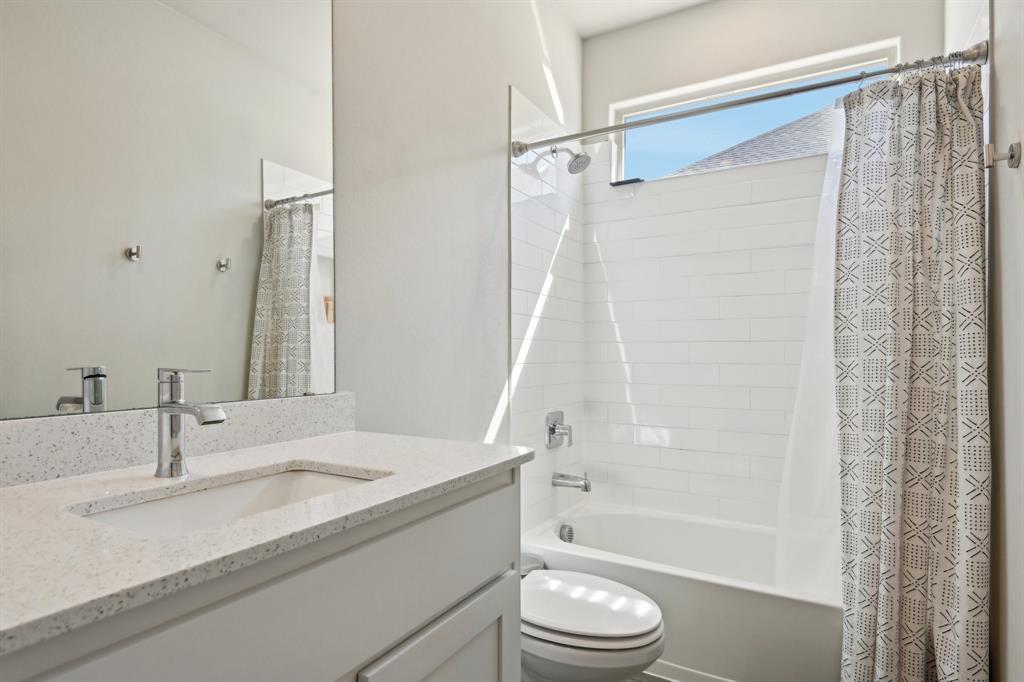 1504 Rachel Street Northlake, TX 76247 - Photo 21 of 40 a bathroom with a granite countertop sink toilet and shower