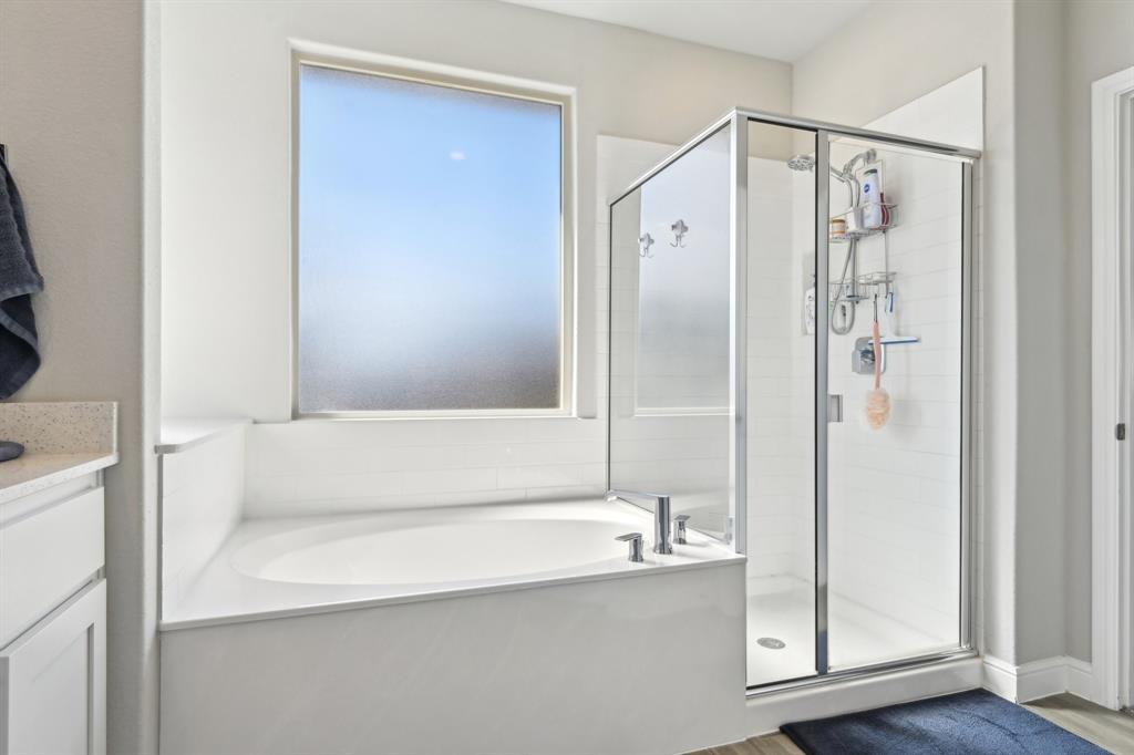 1504 Rachel Street Northlake, TX 76247 - Photo 33 of 40 a bathroom with a bathtub and a shower